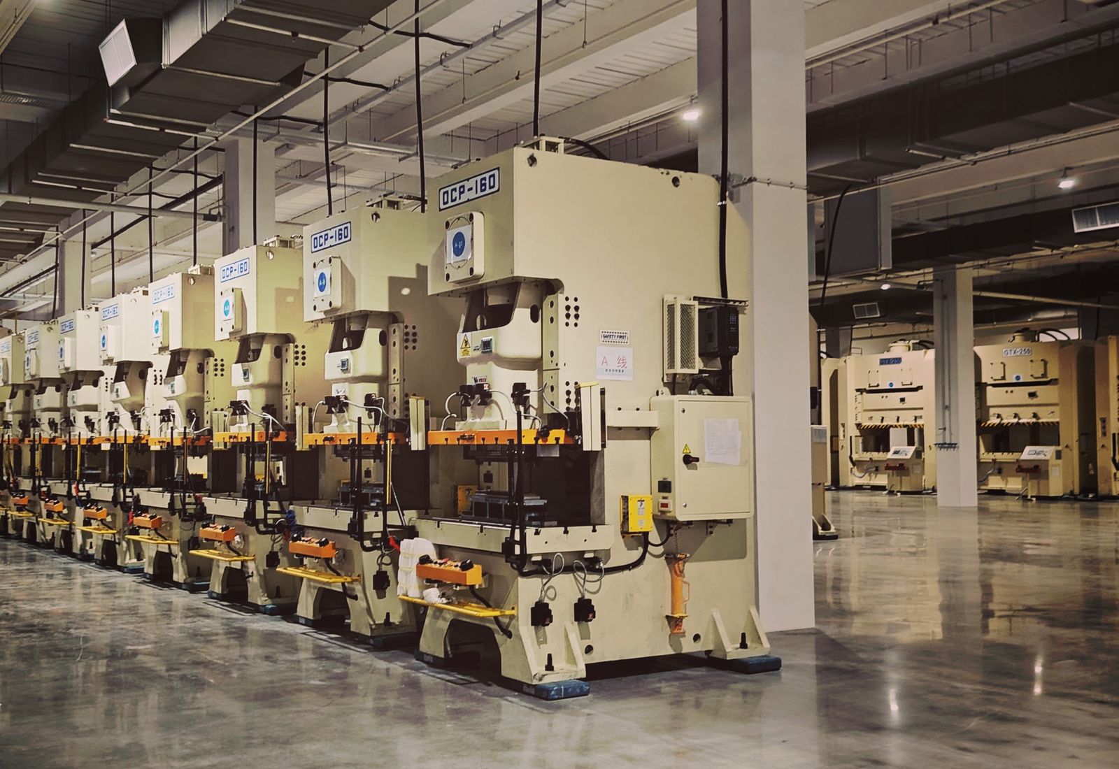 A row of stamping presses on a manufacturing floor