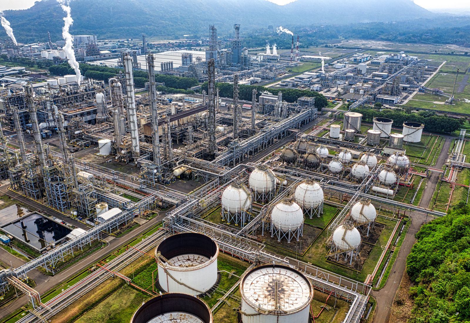 Aerial view of a petrochemical processing plant with storage spheres and tanks